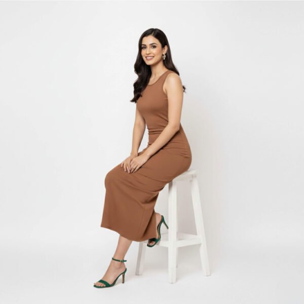 Model wearing a brown sleeveless bodycon dress with a side slit, styled with heels, posing confidently against a plain background.